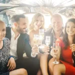 Group of friends celebrating inside luxury party limousine with champagne, highlighting premium limo service for events, nightlife, and special occasions.